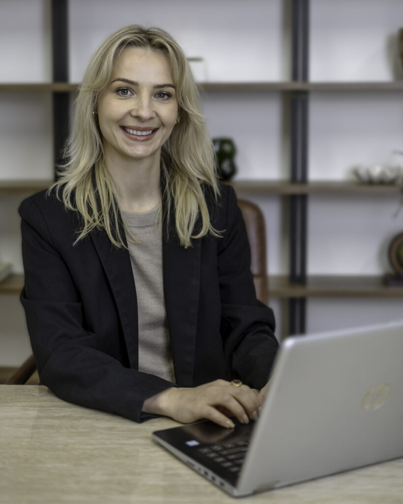 Monika Clayton, South London interior designer, working on a laptop in a calm studio setting