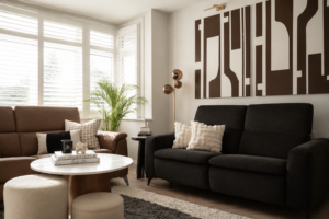 Warm neutral living room with a brown sofa, marble coffee table and indoor plants in natural daylight.