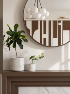 Wellbeing-focused living room with bespoke shelving, fireplace, round mirror and warm neutral furnishings.
